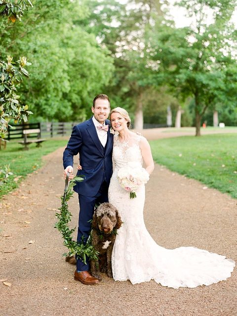 Spring Belle Meade Plantation Wedding with their dog the golden doodle in the wedding wearing a greenery covered leash