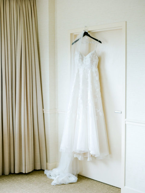 bridal gown dress photo hanging at the Loews Vanderbilt Hotel photo at Benton Chapel at Vanderbilt University Downtown Nashville Wedding | Christy Wilson Photography